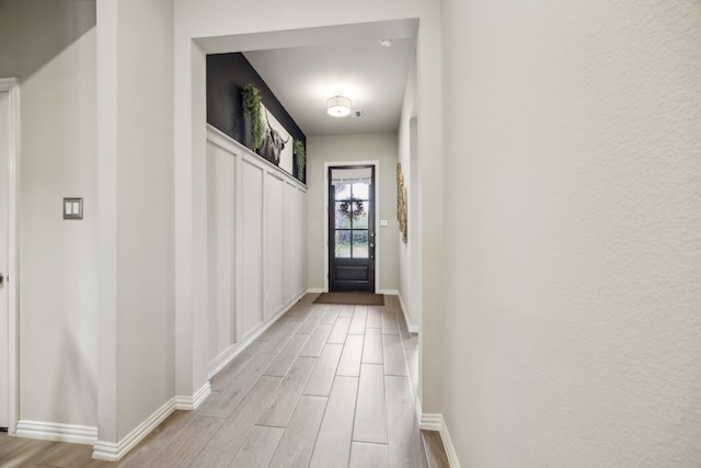 3120 Pioneer Path, Little Elm, TX 75068 - doorway with light wood-style floors and baseboards
