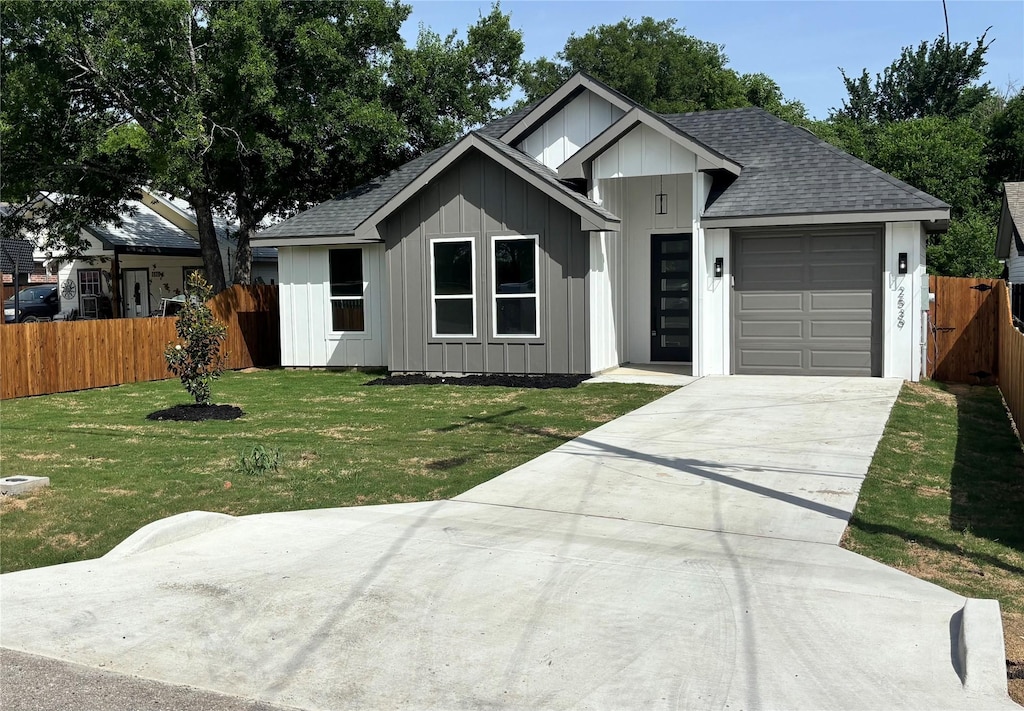 2539 Randolph St, Dallas, TX 75241 - view of front of home featuring board and batten siding, a garage, a shingled roof, and concrete driveway