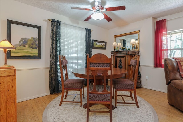 226 Highland Dr, Decatur, TX 76234 - dining space featuring ceiling fan, light wood-style floors, a textured ceiling, and baseboards