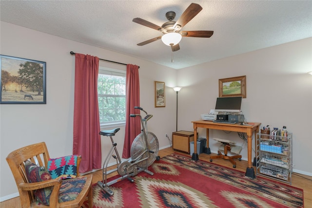 226 Highland Dr, Decatur, TX 76234 - home office featuring ceiling fan, wood finished floors, baseboards, and a textured ceiling