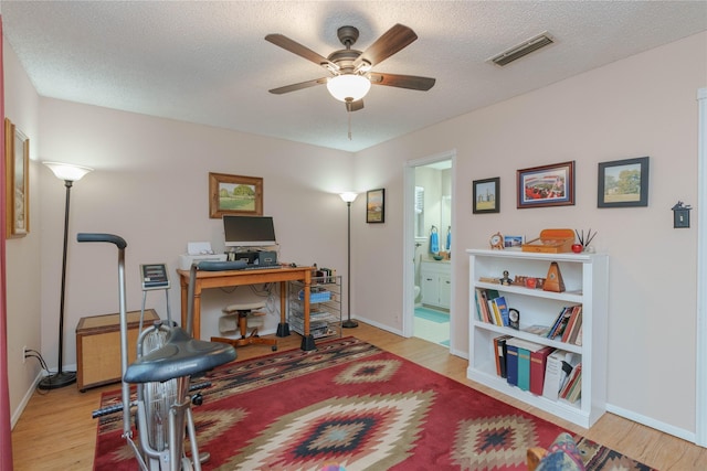 226 Highland Dr, Decatur, TX 76234 - office featuring wood finished floors, ceiling fan, baseboards, and a textured ceiling