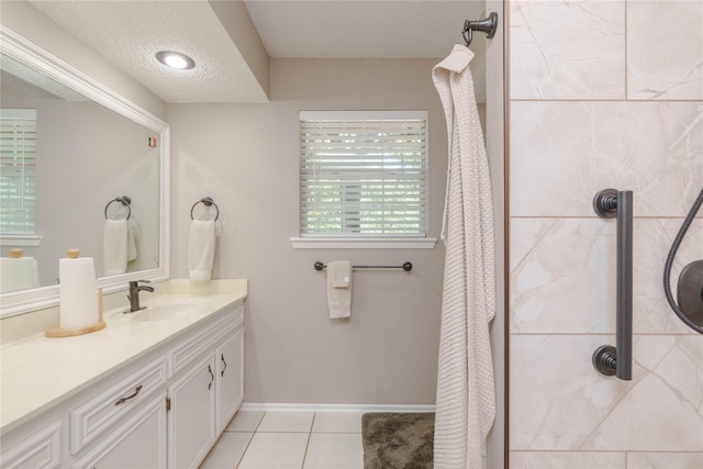 226 Highland Dr, Decatur, TX 76234 - full bath with curtained shower, tile patterned flooring, vanity, a textured ceiling, and baseboards