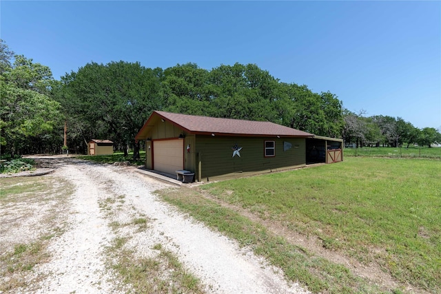226 Highland Dr, Decatur, TX 76234 - view of side of property with an outbuilding, a detached garage, a yard, and driveway