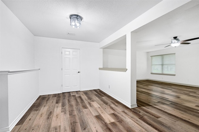 609 E Martin Ln, Sherman, TX 75090 - spare room featuring wood finished floors, baseboards, a textured ceiling, and ceiling fan