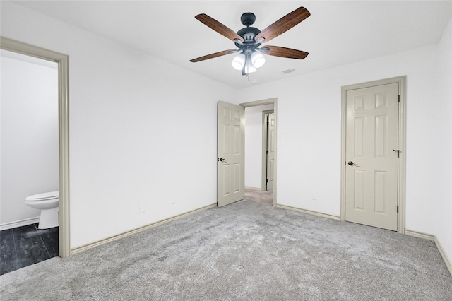 609 E Martin Ln, Sherman, TX 75090 - unfurnished bedroom featuring carpet floors, baseboards, connected bathroom, and ceiling fan