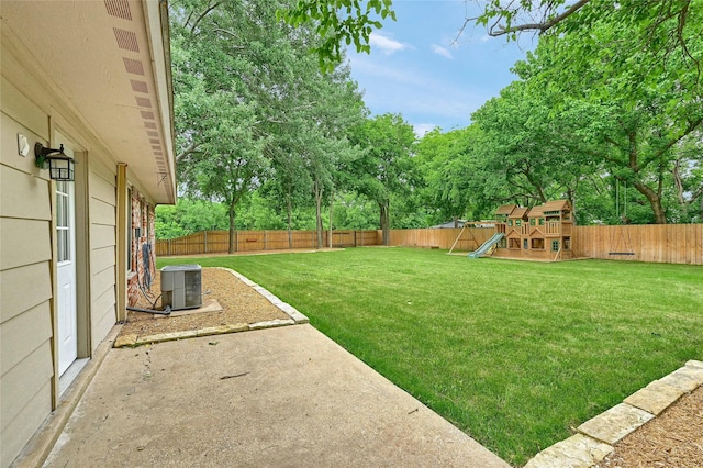 609 E Martin Ln, Sherman, TX 75090 - view of yard featuring a playground, central air condition unit, a patio, and view of wooded area