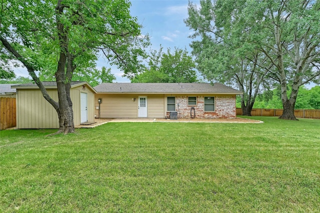 609 E Martin Ln, Sherman, TX 75090 - back of house with central air condition unit, a storage shed, and an outbuilding