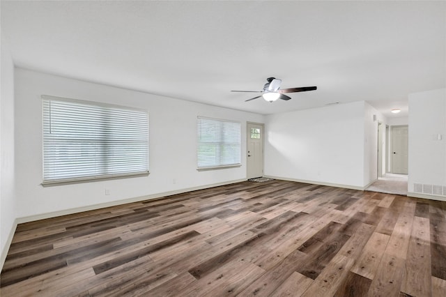 609 E Martin Ln, Sherman, TX 75090 - spare room featuring wood finished floors, ceiling fan, and baseboards