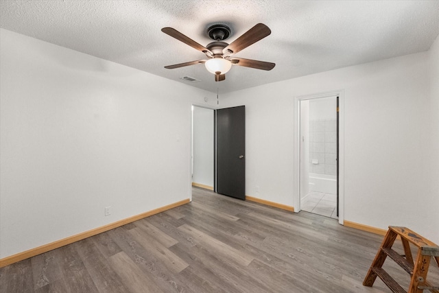 2000 Stacey Ct, Arlington, TX 76013 - unfurnished room featuring wood finished floors, baseboards, and a textured ceiling