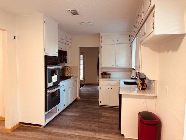 2000 Stacey Ct, Arlington, TX 76013 - kitchen featuring black appliances, white cabinetry, dark wood-style flooring, a sink, and baseboards