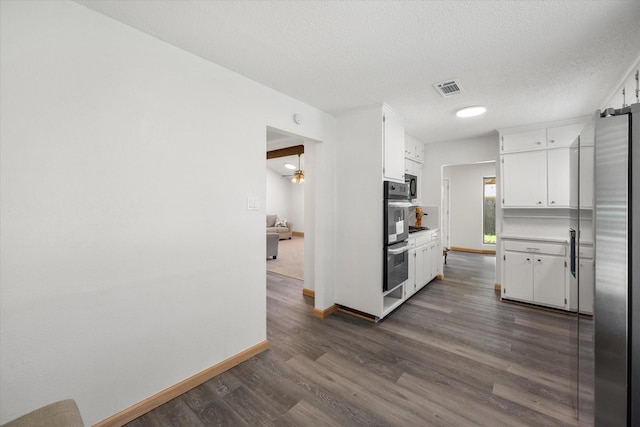 2000 Stacey Ct, Arlington, TX 76013 - kitchen with stainless steel appliances, white cabinetry, dark wood finished floors, baseboards, and light countertops