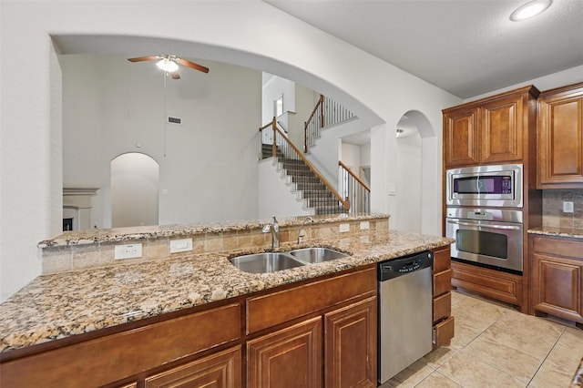 6824 San Fernando Dr, Fort Worth, TX 76131 - kitchen with stainless steel appliances, a sink, ceiling fan, and light stone counters