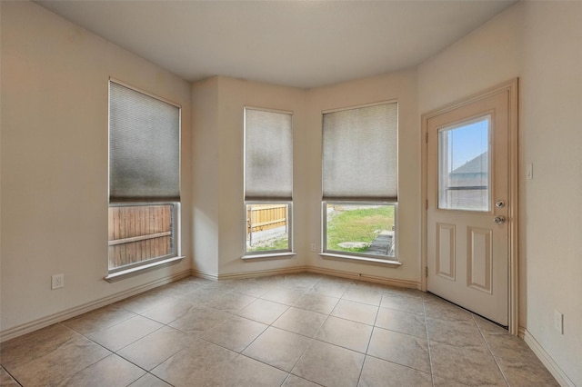 6824 San Fernando Dr, Fort Worth, TX 76131 - entryway featuring plenty of natural light, light tile patterned flooring, and baseboards