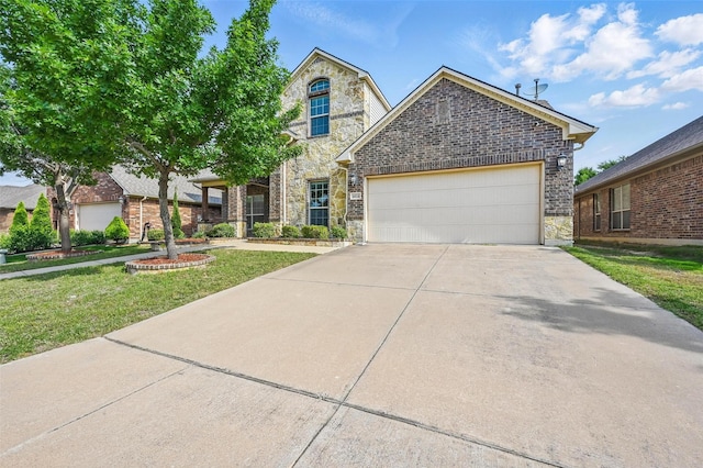 6824 San Fernando Dr, Fort Worth, TX 76131 - view of front of property with concrete driveway, an attached garage, a front yard, and stone siding