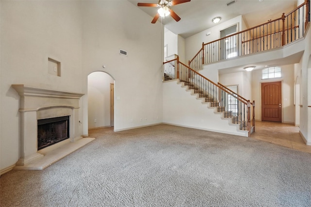 6824 San Fernando Dr, Fort Worth, TX 76131 - unfurnished living room with a towering ceiling, carpet, a ceiling fan, stairway, and baseboards