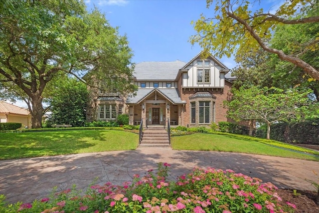 6908 Ridgewood Dr, Fort Worth, TX 76132 - tudor-style house featuring a front yard