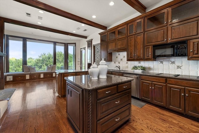 6908 Ridgewood Dr, Fort Worth, TX 76132 - kitchen with stainless steel dishwasher, black microwave, dark wood-type flooring, a sink, and beamed ceiling
