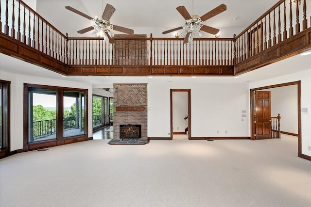 6908 Ridgewood Dr, Fort Worth, TX 76132 - unfurnished living room featuring a towering ceiling, carpet, baseboards, ceiling fan, and a brick fireplace