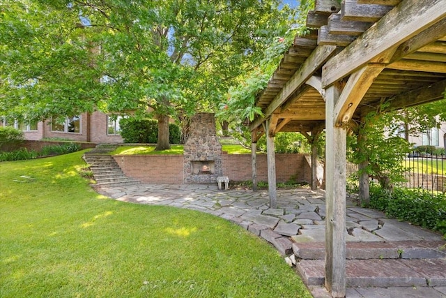 6908 Ridgewood Dr, Fort Worth, TX 76132 - view of yard with an outdoor stone fireplace and a patio area