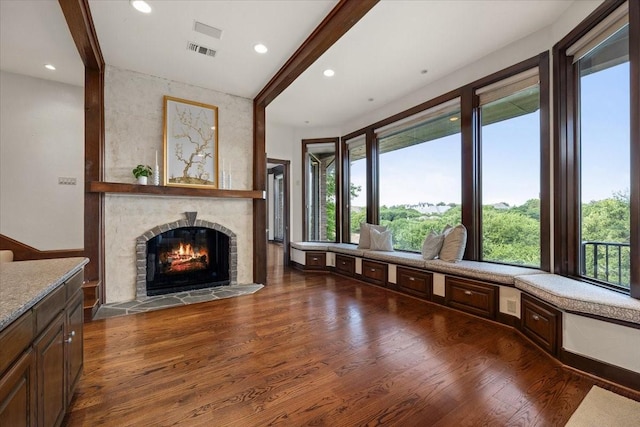 6908 Ridgewood Dr, Fort Worth, TX 76132 - unfurnished living room with dark wood-style flooring, healthy amount of natural light, a lit fireplace, and recessed lighting
