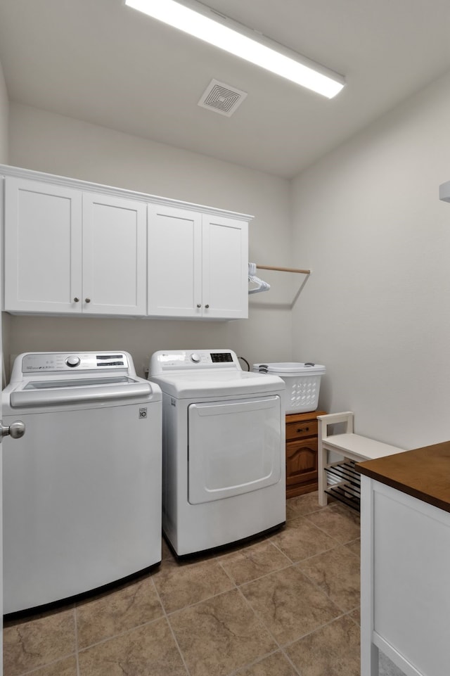 2420 Rooster Ln, Northlake, TX 76247 - laundry area featuring washer and clothes dryer, cabinet space, and light tile patterned flooring