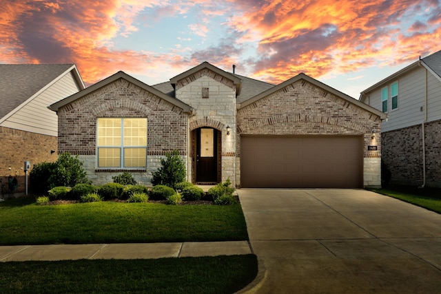 2420 Rooster Ln, Northlake, TX 76247 - french country style house with an attached garage, concrete driveway, stone siding, brick siding, and a yard