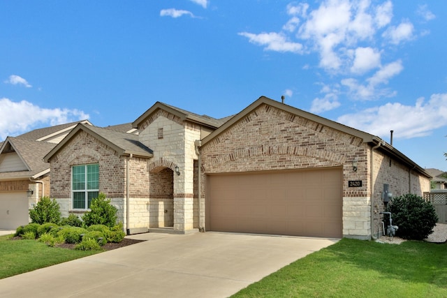 2420 Rooster Ln, Northlake, TX 76247 - view of front of property with brick siding, an attached garage, concrete driveway, stone siding, and a front yard