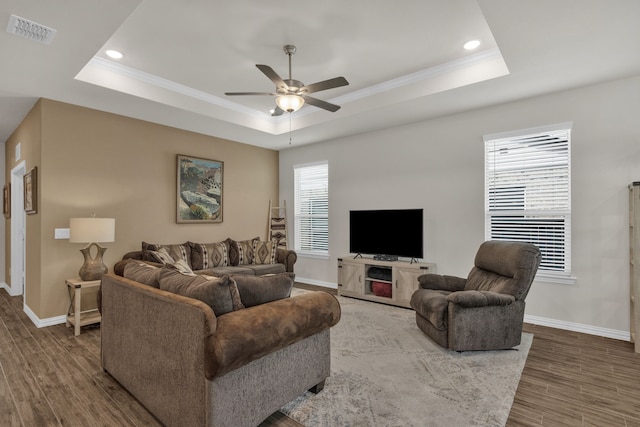 2420 Rooster Ln, Northlake, TX 76247 - living room featuring a raised ceiling, baseboards, crown molding, ceiling fan, and wood finished floors