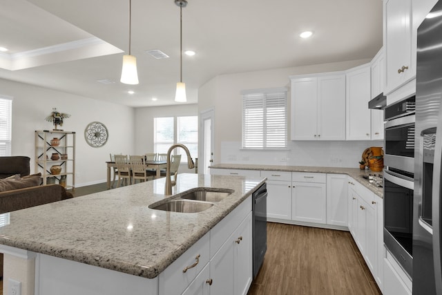 2420 Rooster Ln, Northlake, TX 76247 - kitchen featuring a sink, appliances with stainless steel finishes, ornamental molding, an island with sink, and decorative backsplash
