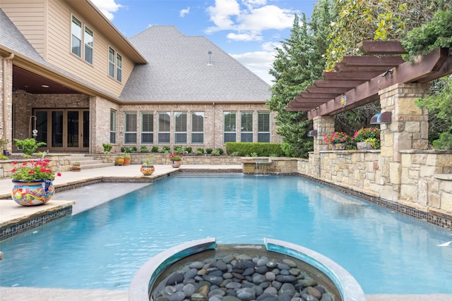 view of swimming pool featuring a pool with connected hot tub, a patio area, french doors, and a pergola