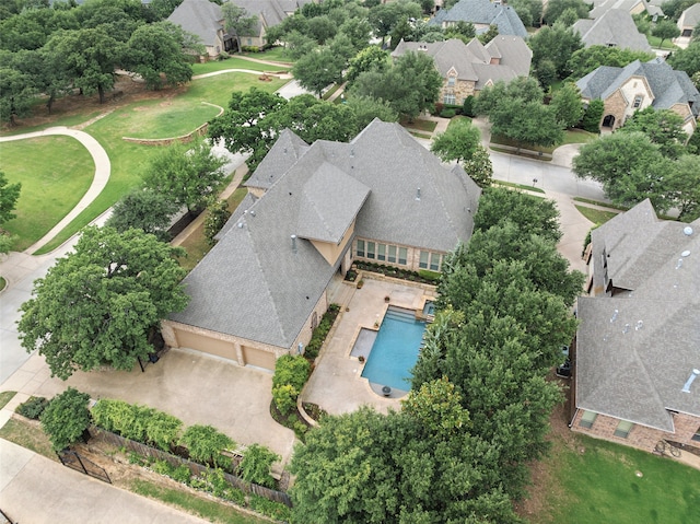 aerial perspective of suburban area featuring a pool