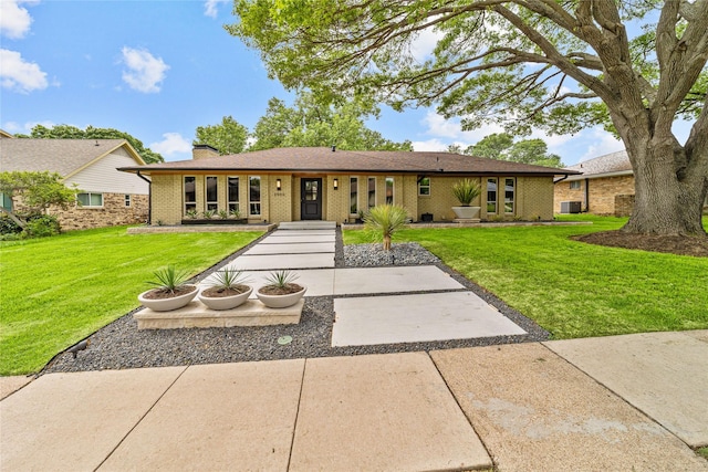 2500 Mollimar Dr, Plano, TX 75075 - ranch-style house featuring brick siding, a front lawn, and a chimney