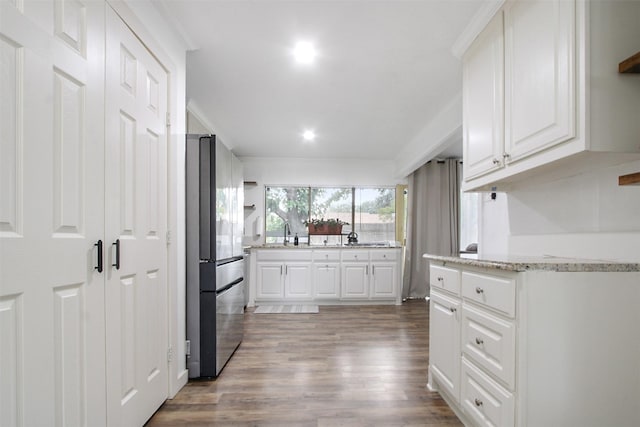 917 Park E Cir, Garland, TX 75043 - kitchen featuring freestanding refrigerator, wood finished floors, white cabinetry, light stone counters, and recessed lighting