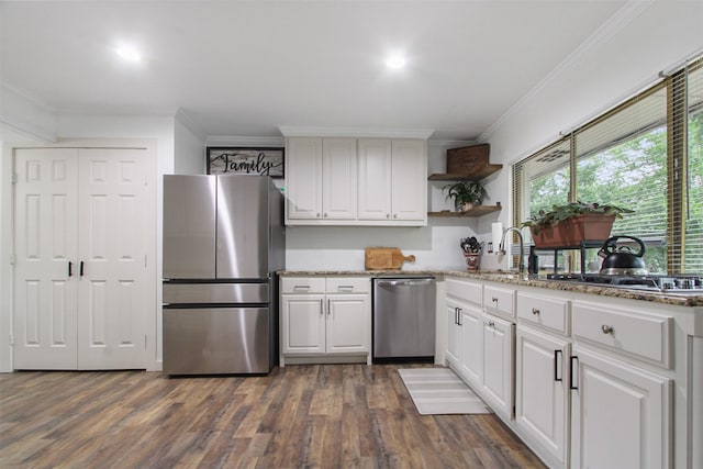 917 Park E Cir, Garland, TX 75043 - kitchen featuring appliances with stainless steel finishes, crown molding, open shelves, dark wood-type flooring, and light stone countertops