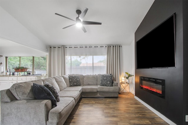 917 Park E Cir, Garland, TX 75043 - living area with vaulted ceiling, ceiling fan, a glass covered fireplace, and dark wood-style flooring