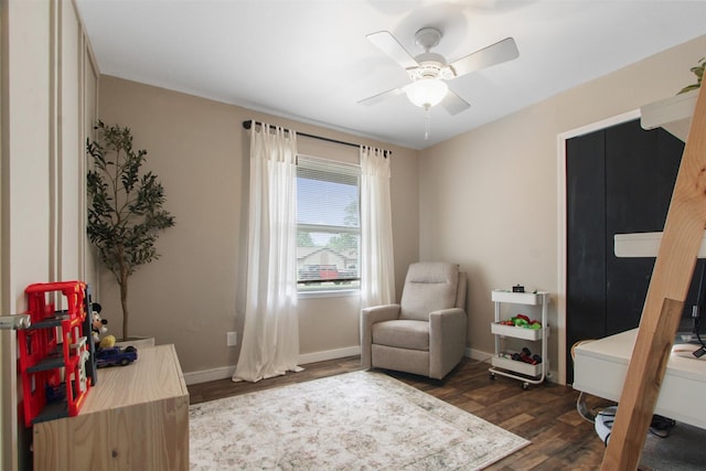 917 Park E Cir, Garland, TX 75043 - sitting room with a ceiling fan, dark wood-type flooring, and baseboards