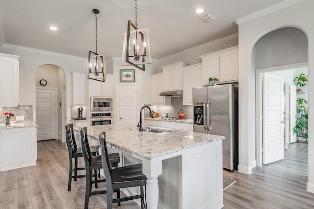 233 Honey Brook Ln, Aledo, TX 76008 - kitchen featuring stainless steel appliances, a sink, arched walkways, tasteful backsplash, and crown molding
