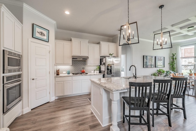 233 Honey Brook Ln, Aledo, TX 76008 - kitchen with appliances with stainless steel finishes, a sink, ornamental molding, a chandelier, and decorative backsplash