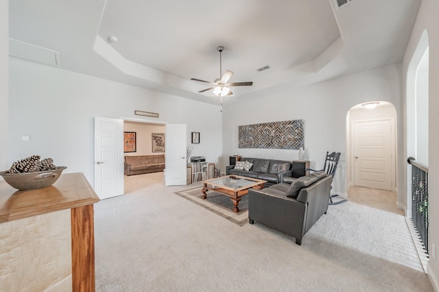 233 Honey Brook Ln, Aledo, TX 76008 - living room featuring a raised ceiling, carpet floors, ceiling fan, and arched walkways