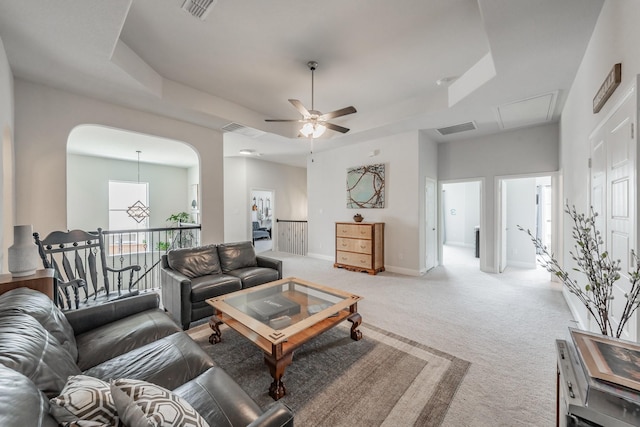 233 Honey Brook Ln, Aledo, TX 76008 - carpeted living area with a tray ceiling, ceiling fan, baseboards, arched walkways, and attic access