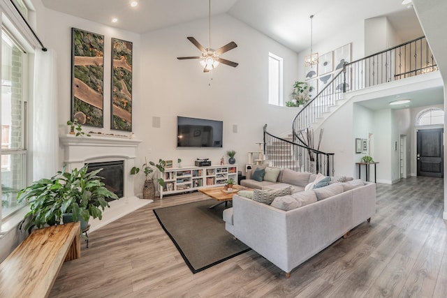 233 Honey Brook Ln, Aledo, TX 76008 - living area with high vaulted ceiling, stairs, a ceiling fan, wood finished floors, and healthy amount of natural light