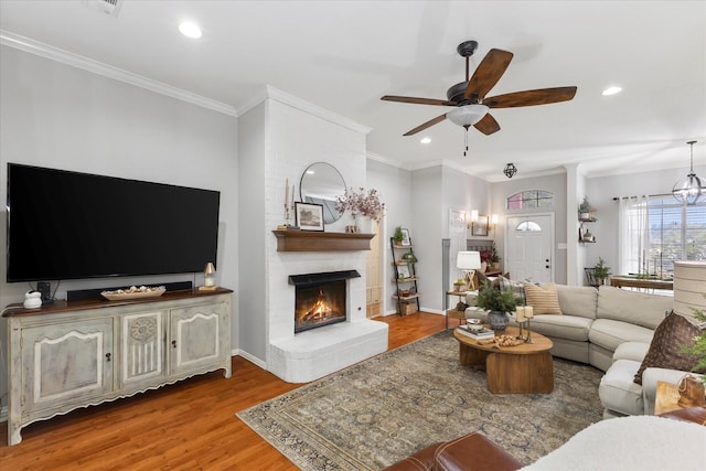 110 Stanford, Forney, TX 75126 - living room featuring ceiling fan, a brick fireplace, wood finished floors, crown molding, and recessed lighting