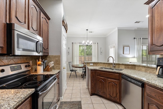 110 Stanford, Forney, TX 75126 - kitchen with appliances with stainless steel finishes, a sink, a chandelier, light tile patterned flooring, and decorative backsplash