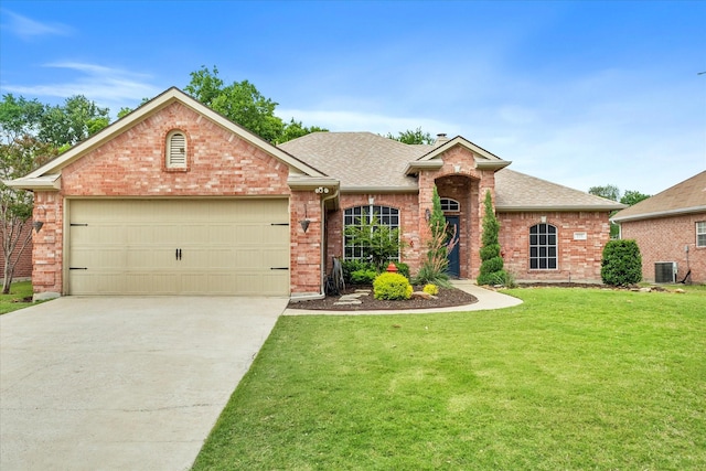 110 Stanford, Forney, TX 75126 - view of front of house featuring brick siding, roof with shingles, a front yard, concrete driveway, and a garage