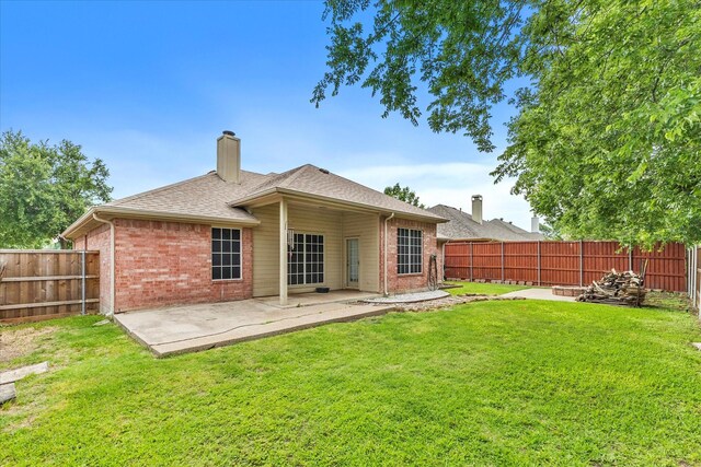 110 Stanford, Forney, TX 75126 - rear view of house with brick siding, a chimney, a patio area, and a shingled roof