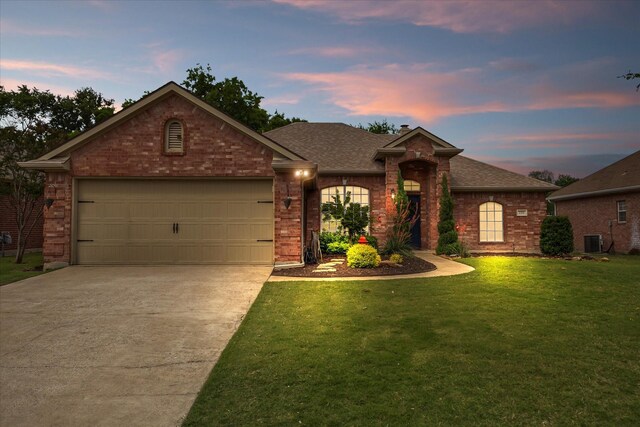 110 Stanford, Forney, TX 75126 - view of front of home featuring concrete driveway, a lawn, a garage, brick siding, and central air condition unit