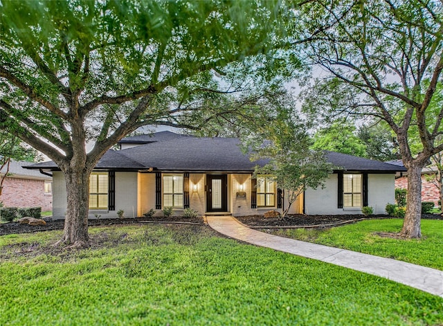 7323 Whispering Pines Dr, Dallas, TX 75248 - view of front of property with brick siding, a front yard, and roof with shingles