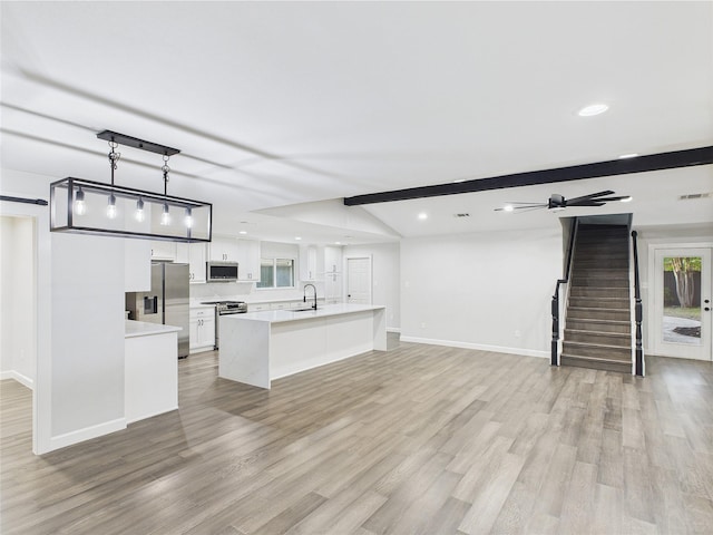 7323 Whispering Pines Dr, Dallas, TX 75248 - unfurnished living room featuring a sink, light wood-style floors, baseboards, recessed lighting, and stairway