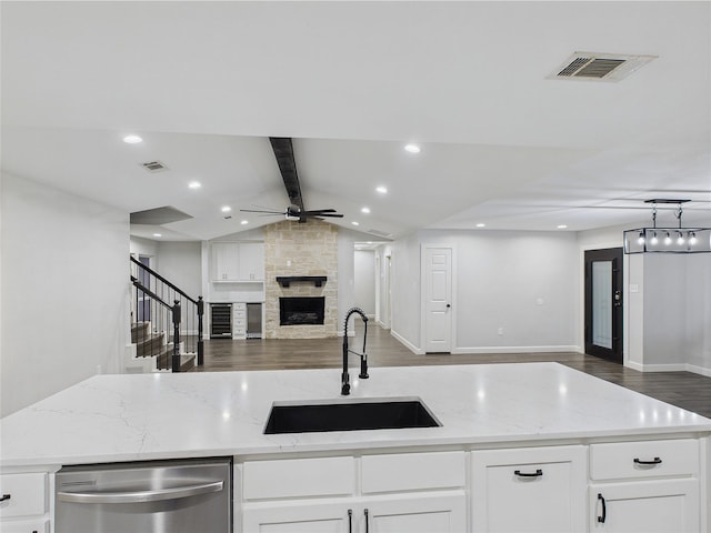 7323 Whispering Pines Dr, Dallas, TX 75248 - kitchen featuring a sink, open floor plan, dishwasher, a ceiling fan, and a large fireplace