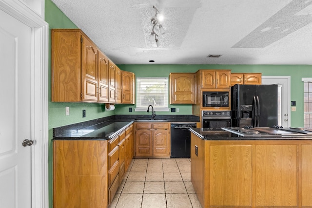 10201 Buffalo Grove Rd, Fort Worth, TX 76108 - kitchen with black appliances, a sink, a textured ceiling, track lighting, and light tile patterned floors